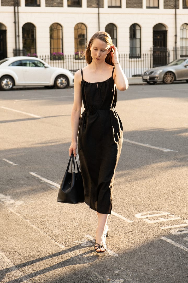 a lady in a black slip dress made of xiangyun silk